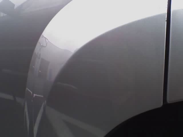a close up of a car 's fender on a foggy day .
