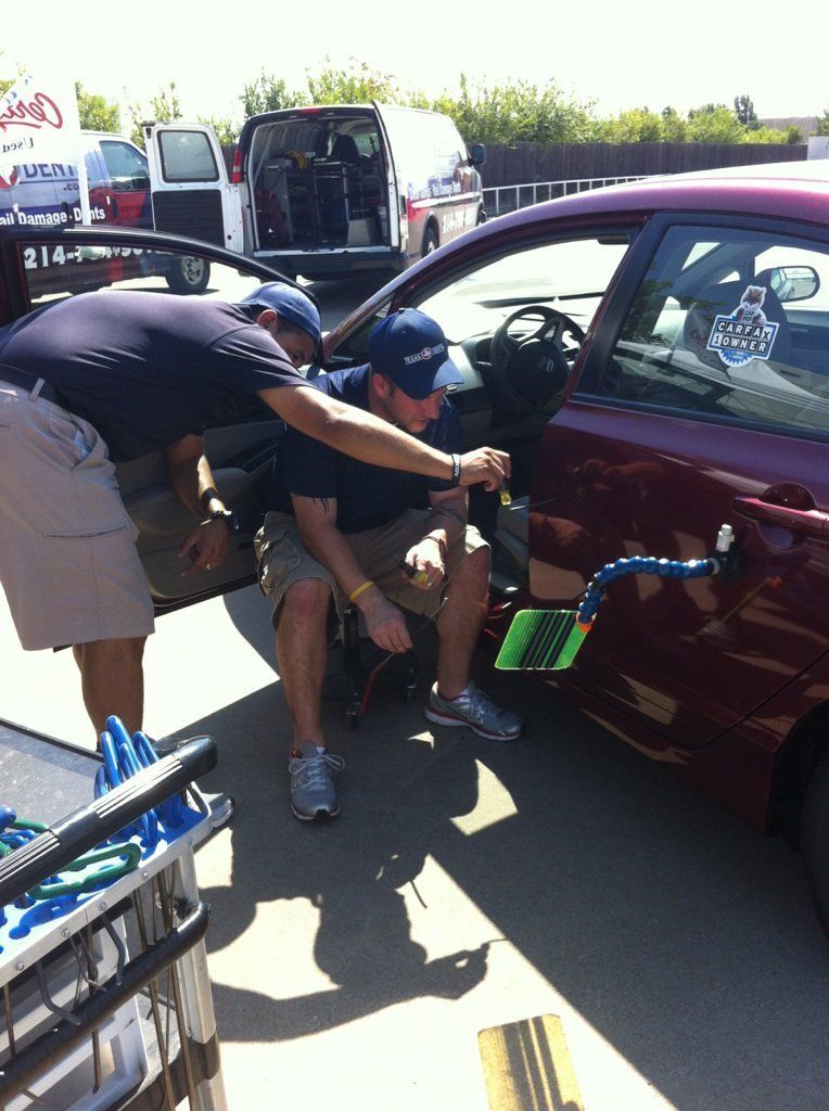 two men are working on a car with the number 314 on the back