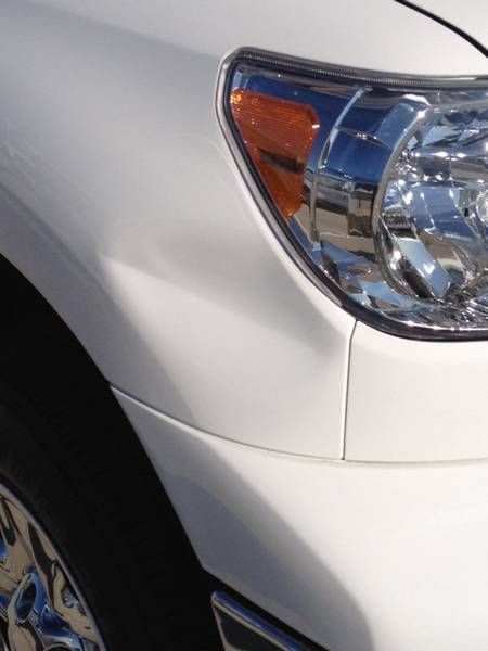 a close up of a white car 's headlight
