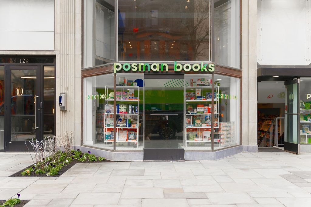 Front entrance of Postman Books, a modern storefront with glass doors and book displays.