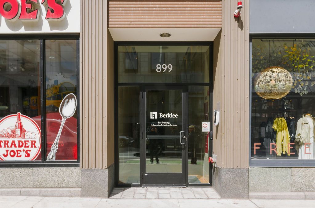 Storefront entrance with glass door and number 399, flanked by Trader Joe’s window displays.