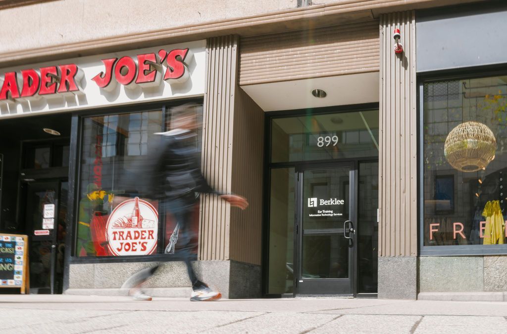 Trader Joe’s storefront with a person walking past the entrance