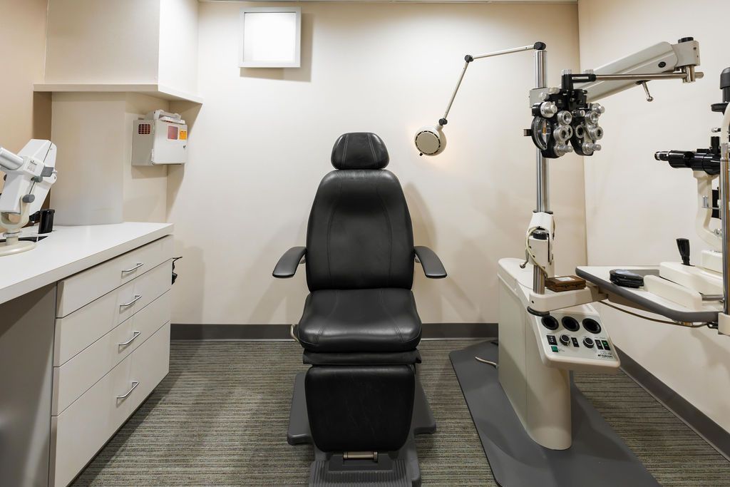 Dental exam room with chair, overhead light, and instruments on both sides