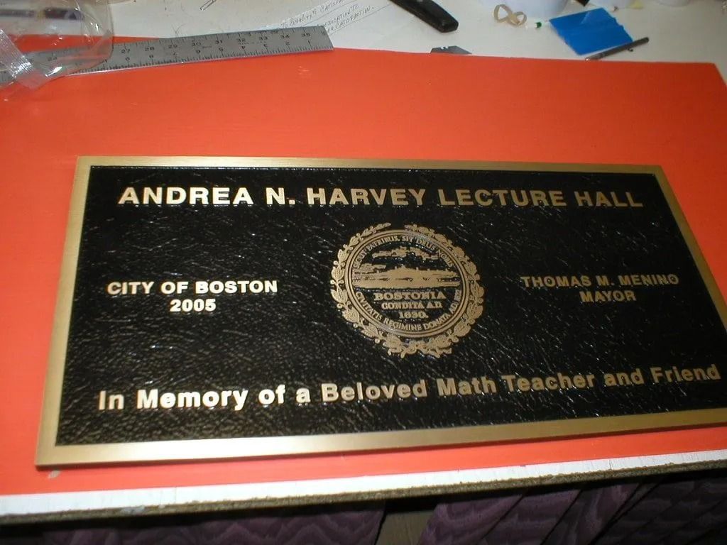 A black and gold commemorative plaque titled 