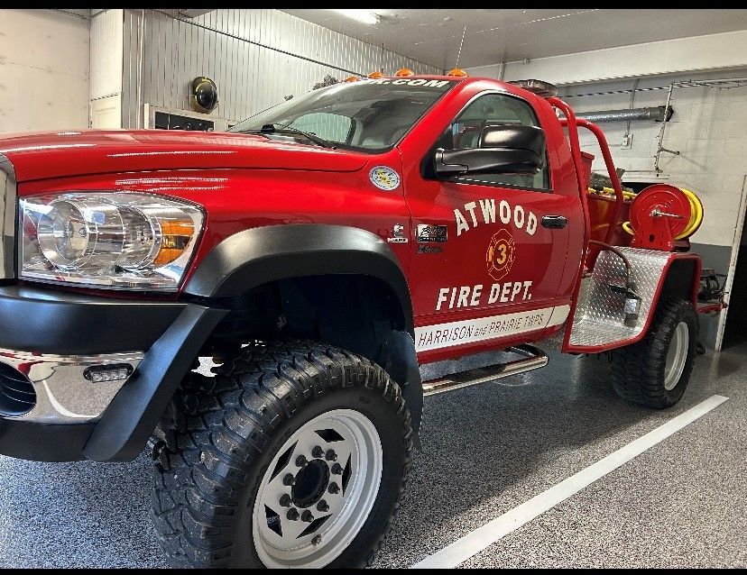 Red fire department pickup truck parked indoors, marked Atwood Fire Dept.