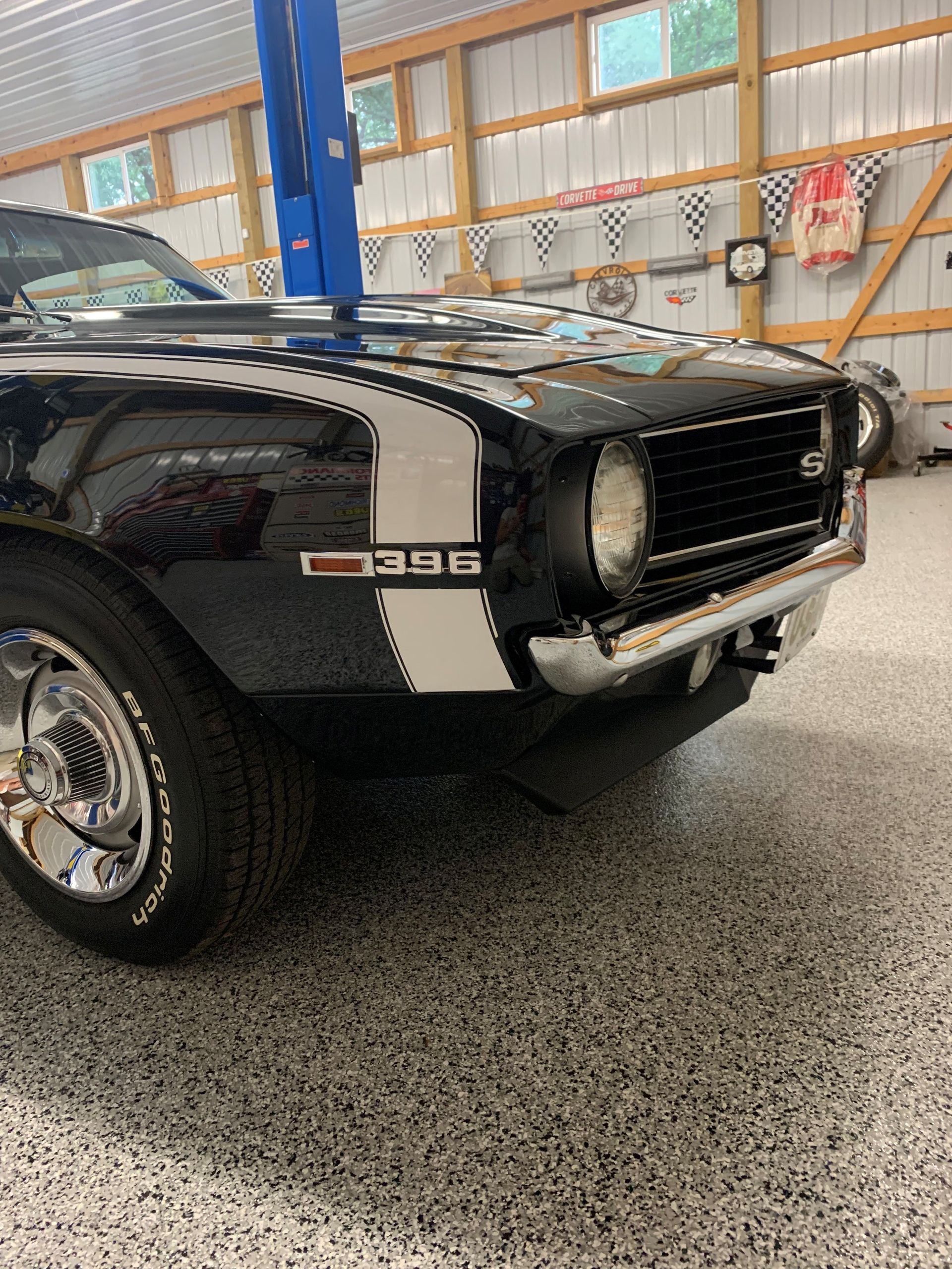 Black classic muscle car in a garage, front quarter view with chrome grille and GT 390 badge