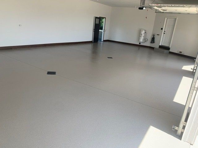 Empty beige room with white walls, a doorway, and sunlight on the floor