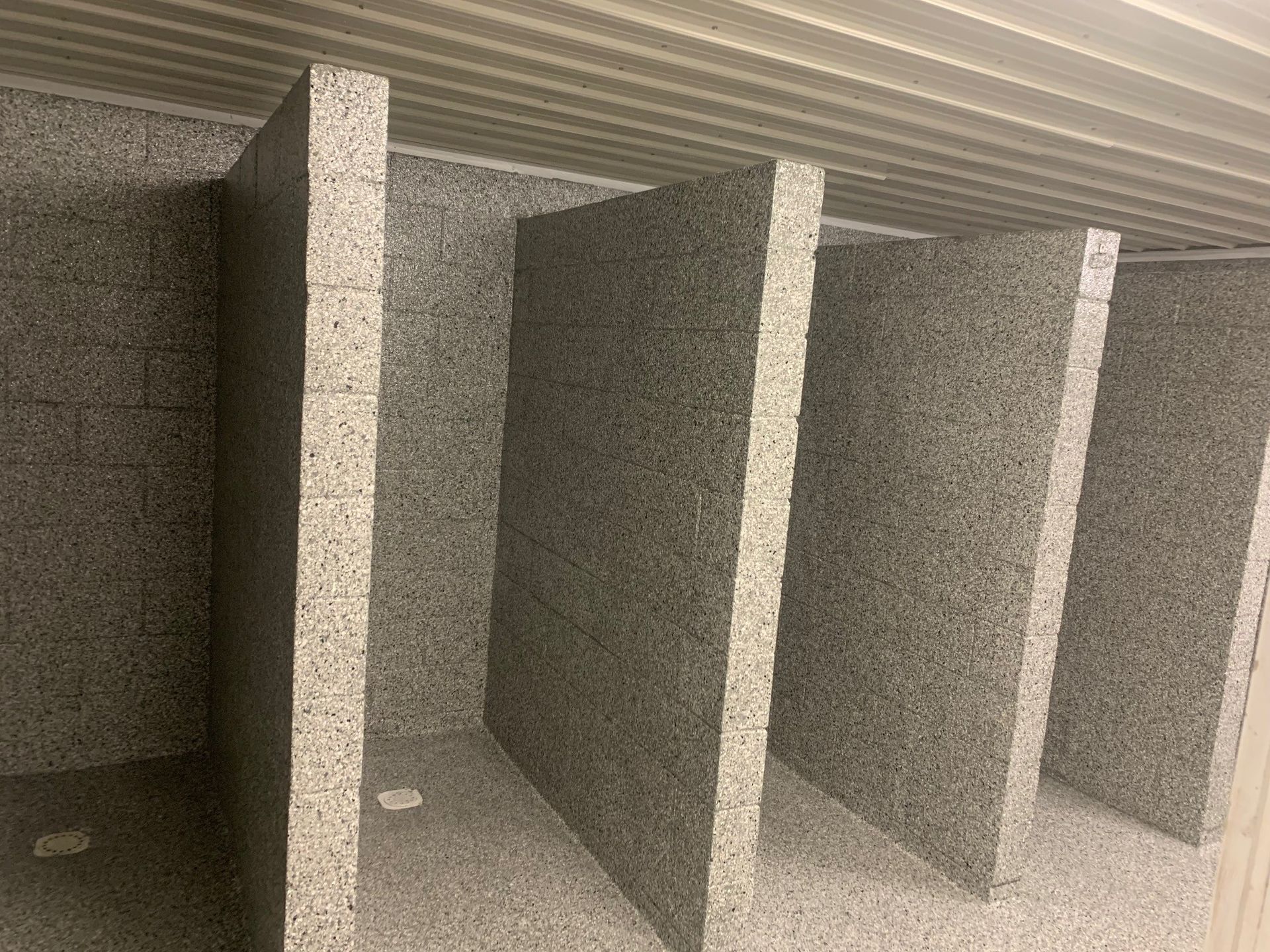 Empty gray storage lockers with open compartments and metal dividers