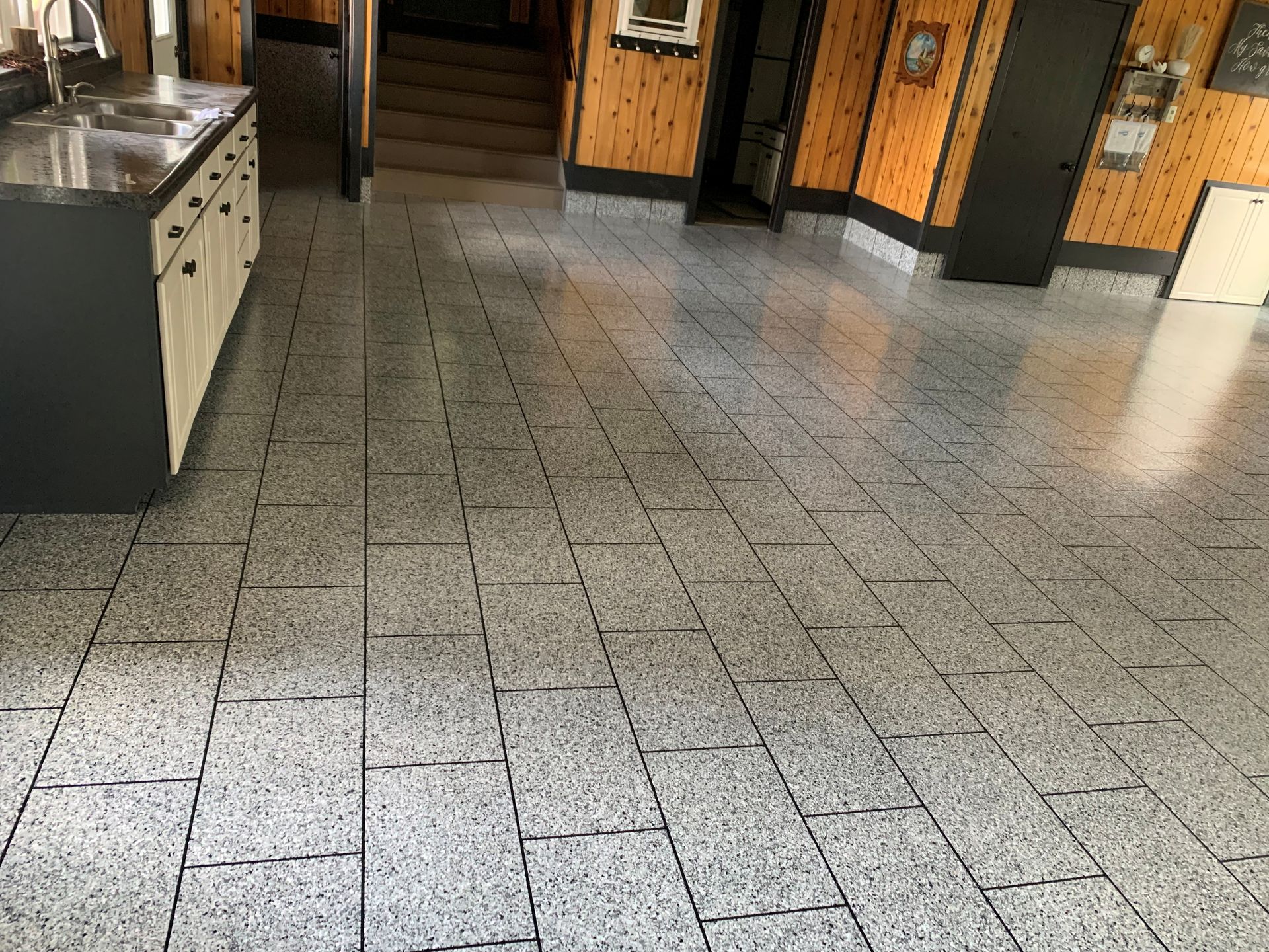Empty tiled restaurant floor with booths and counters in the background