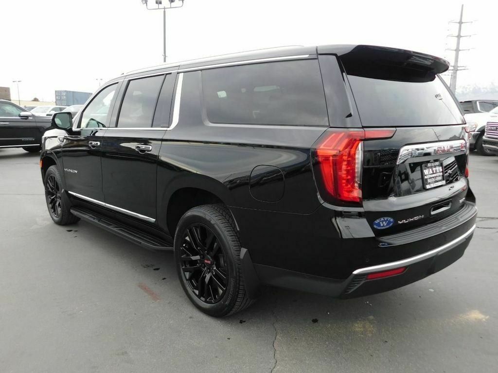 Black GMC Yukon SUV parked on asphalt.