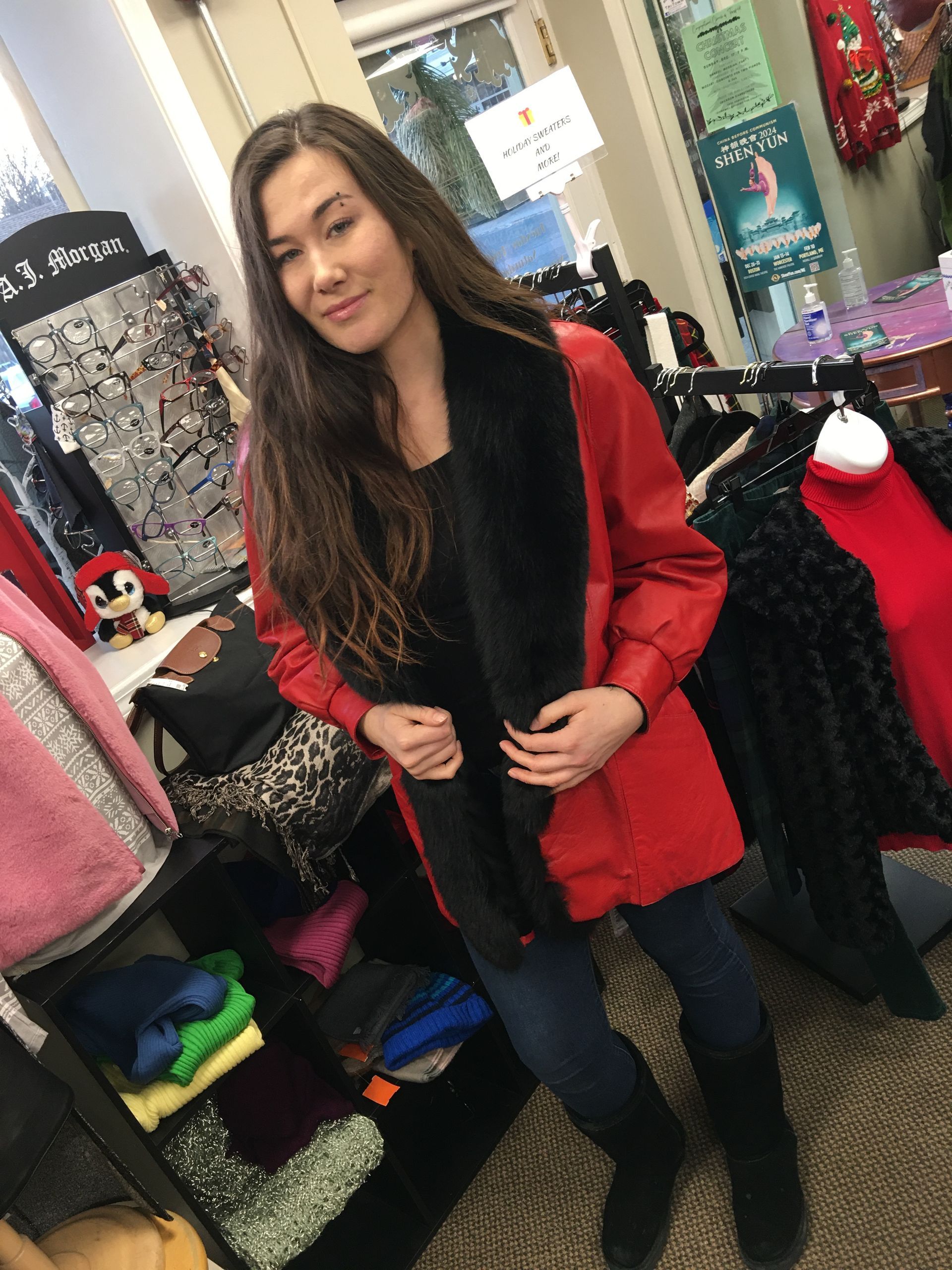 a woman is wearing a red jacket with a black fur collar