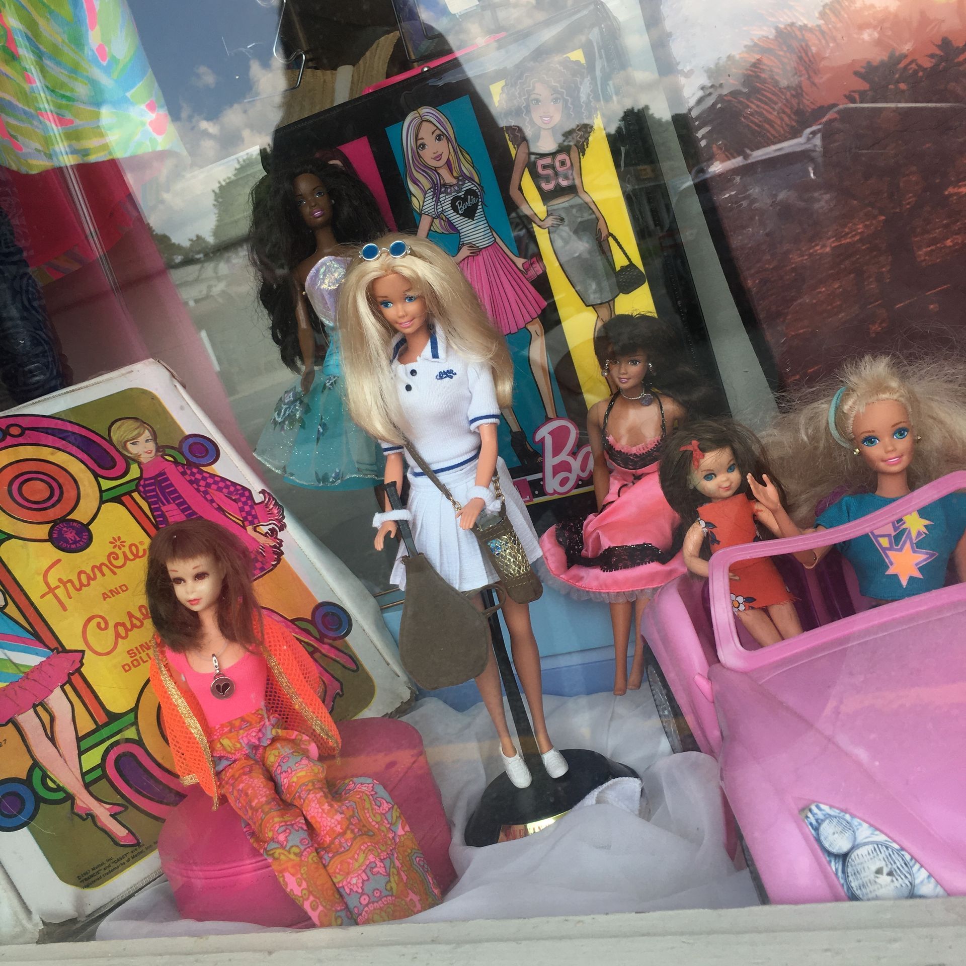 a display of barbie dolls in a store window