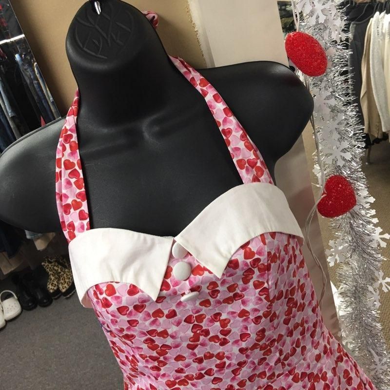 a mannequin wearing a pink and white dress with hearts on it