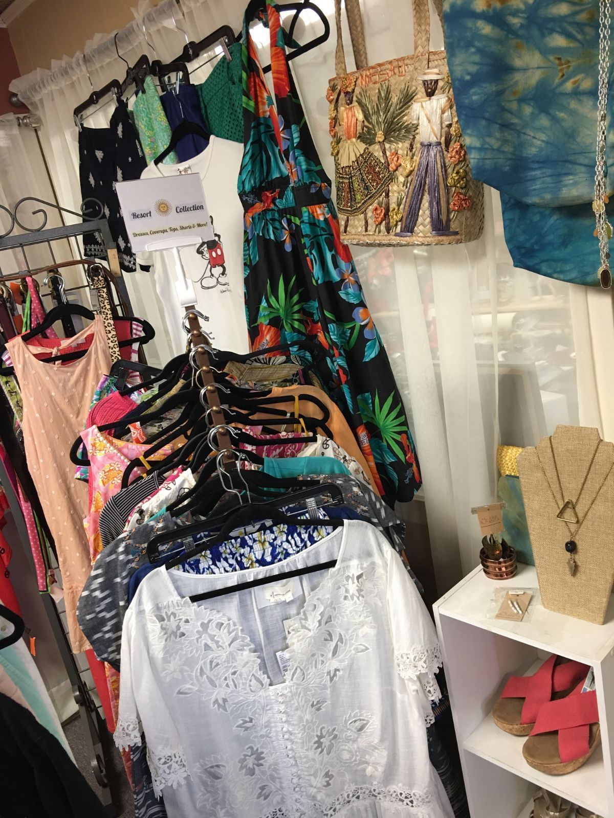 a bunch of clothes are hanging on a rack in a store