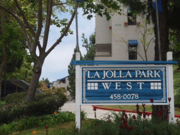 Sign for La Jolla Park West apartment complex with blue and white colors.