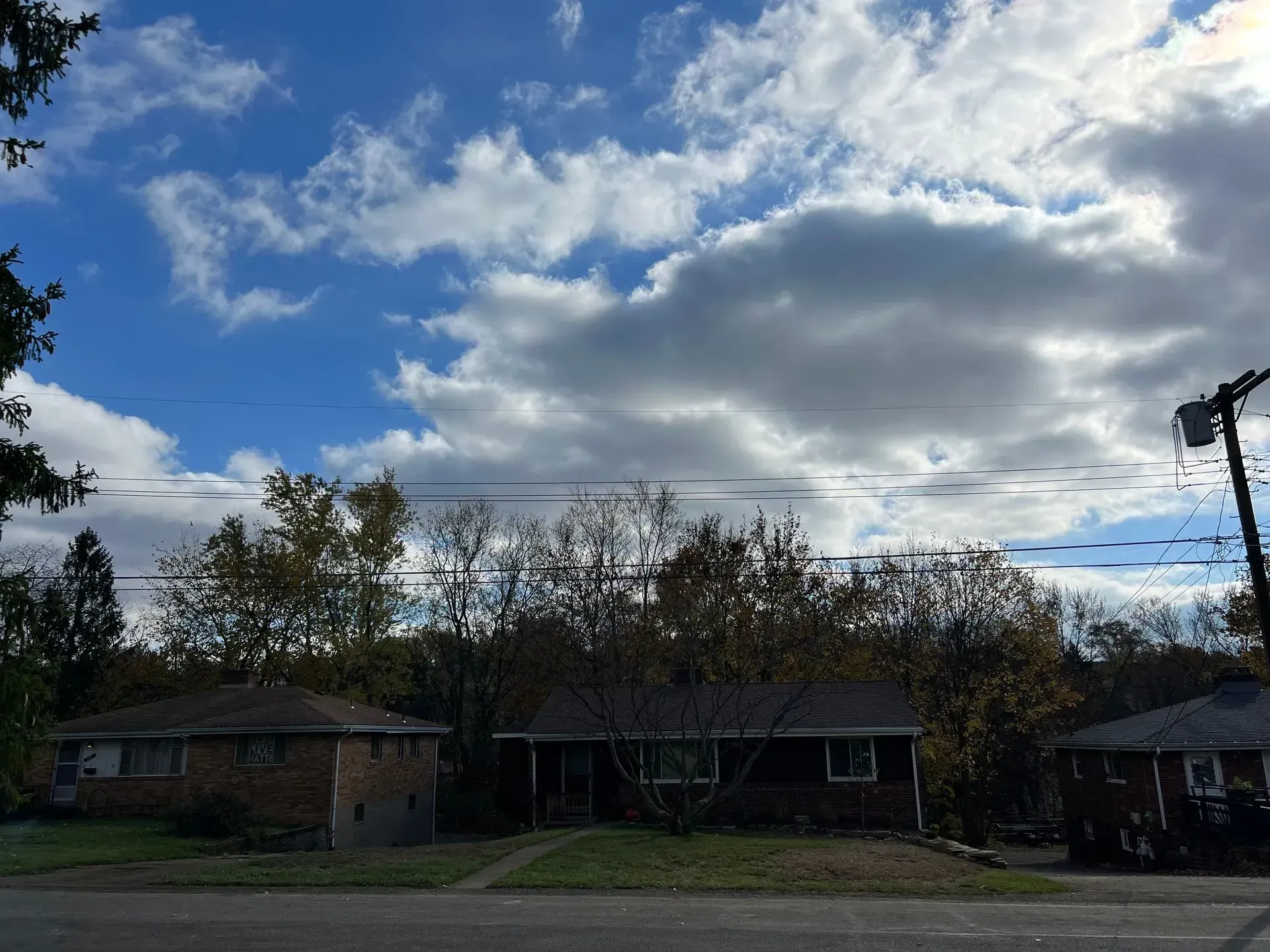 Residential homes under a cloudy blue sky.