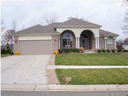 Suburban house with two-car garage, arched front porch, and a driveway in front