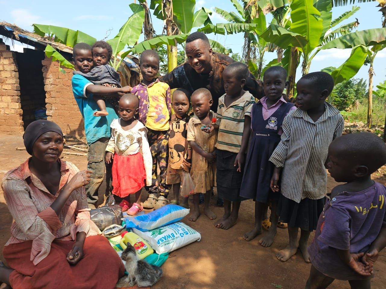 Group of people with supplies standing outside a building.