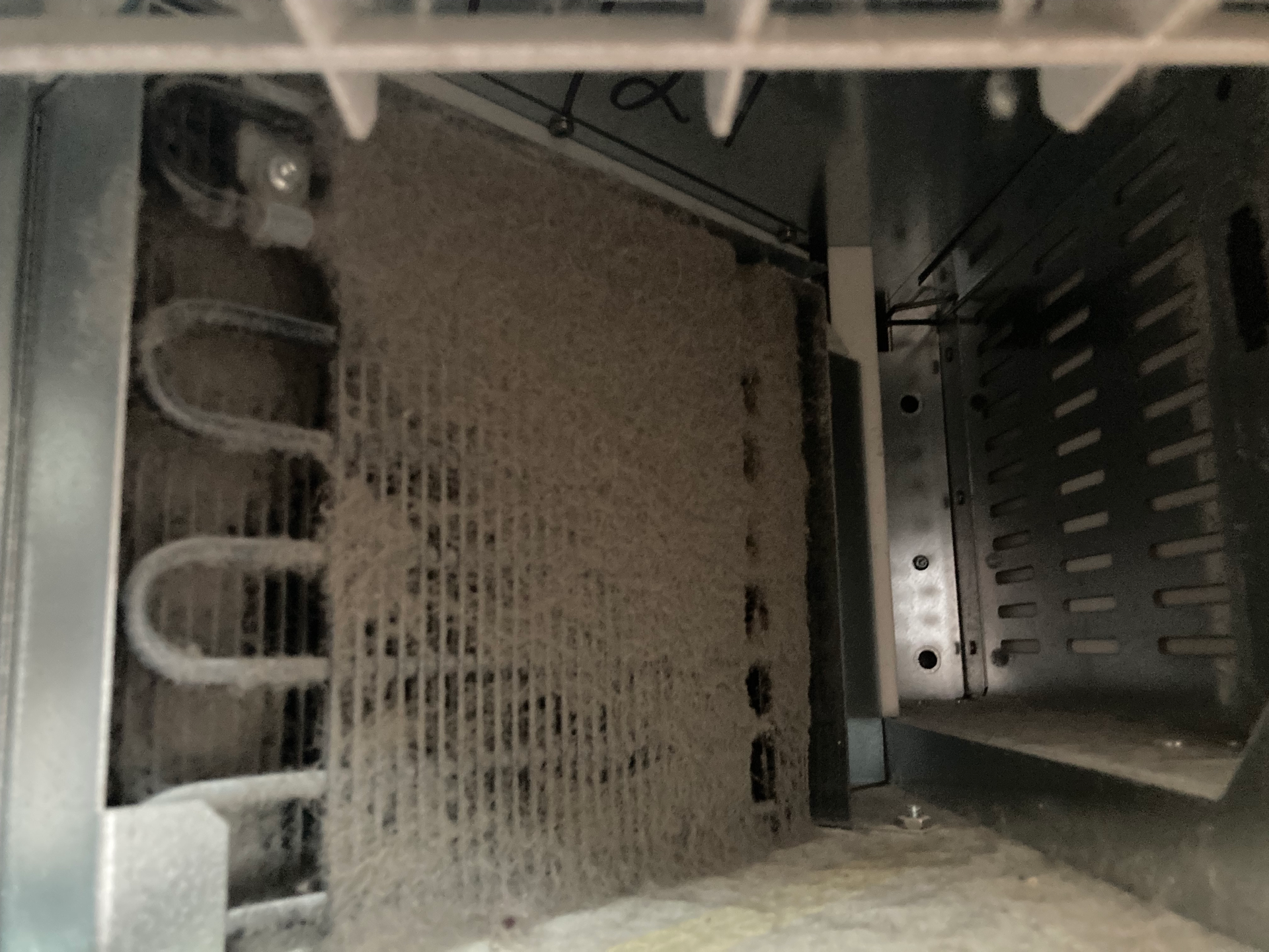 Dust-covered metal components inside a computer tower.