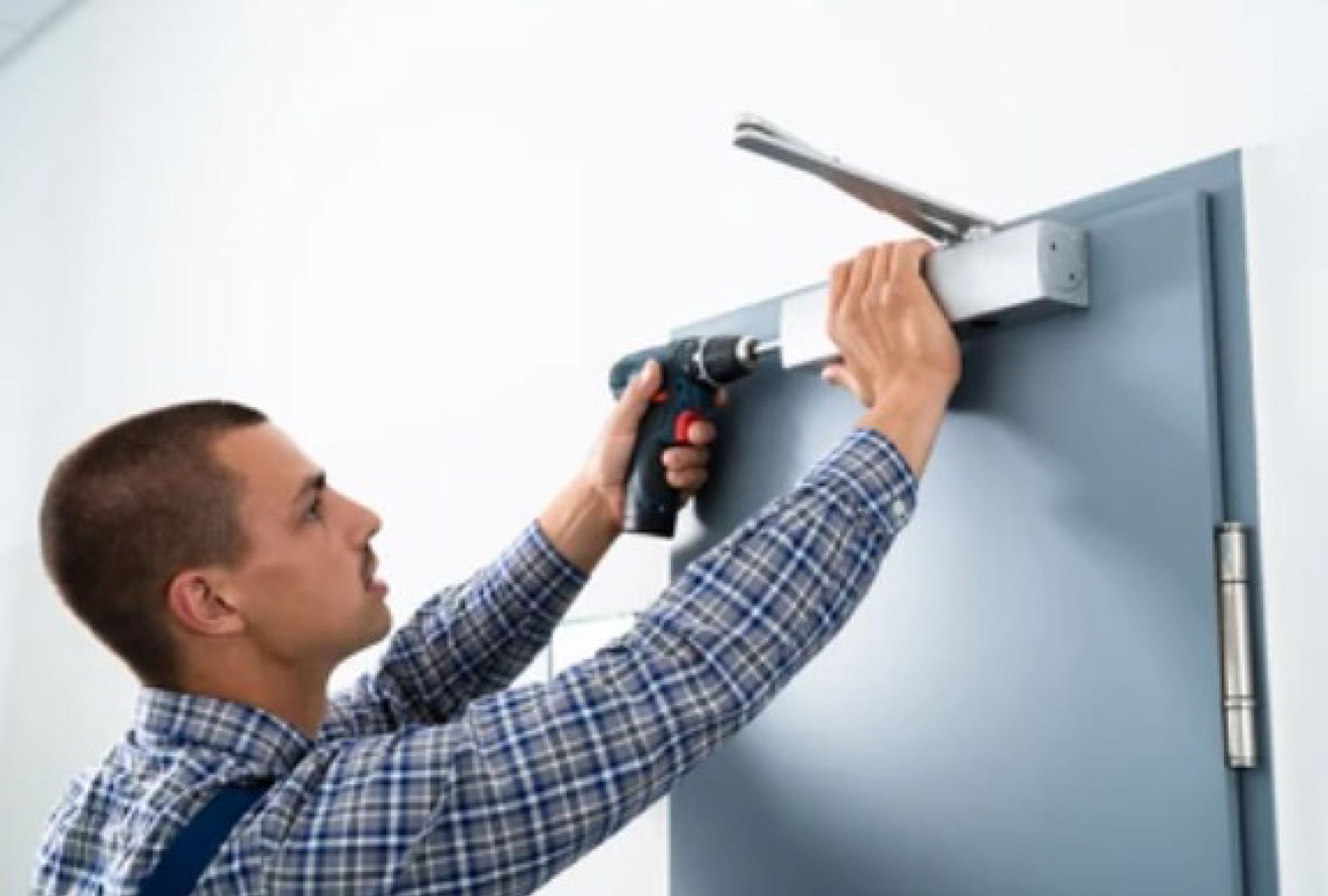 A man is installing a door with a drill.