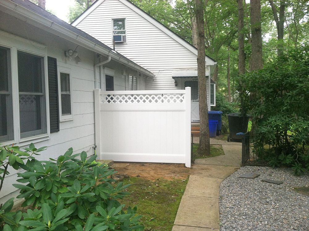 White house exterior with white fence and a pathway.