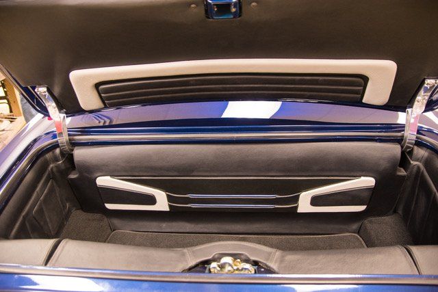 Blue car trunk interior with gray and black trim.