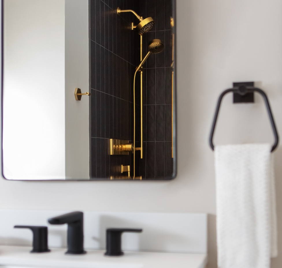 A bathroom with a sink a mirror and a shower