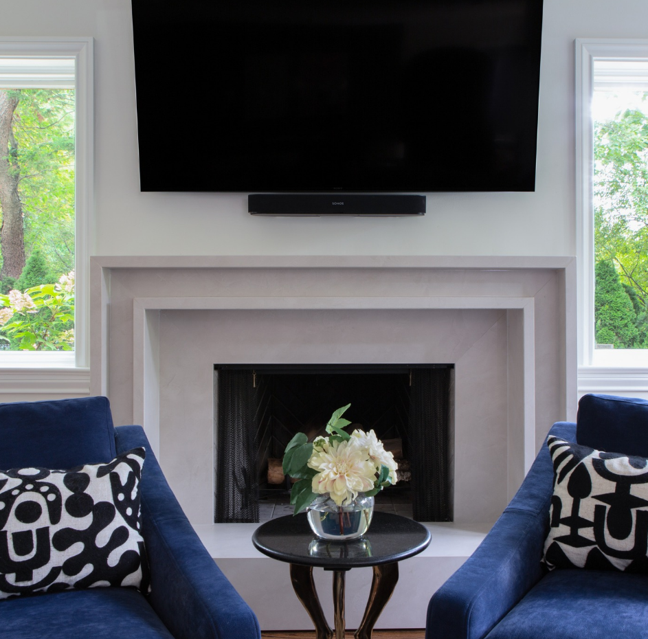 A living room with a fireplace and a flat screen tv