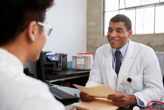 man talking to a doctor