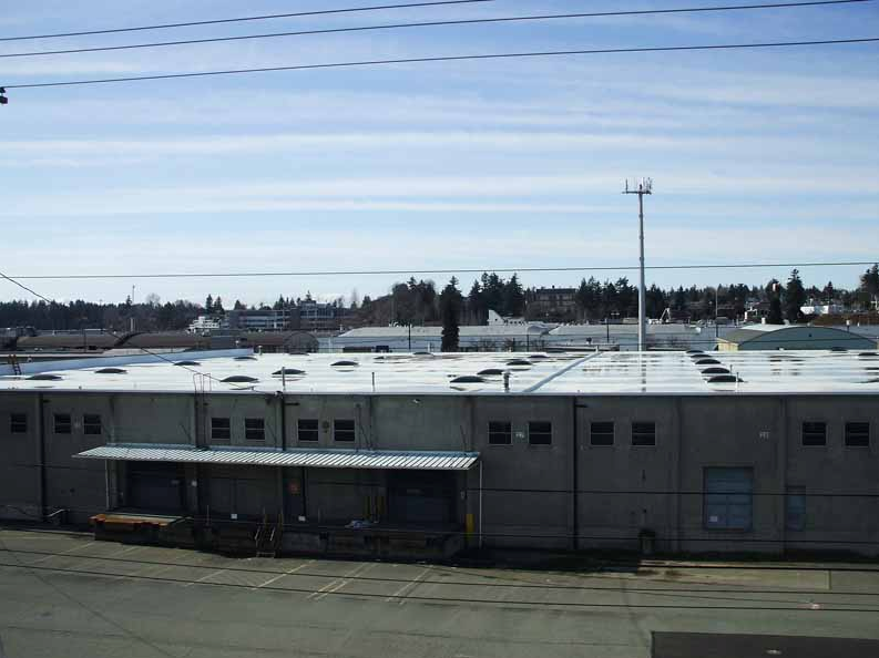 A large building with a lot of windows on the roof