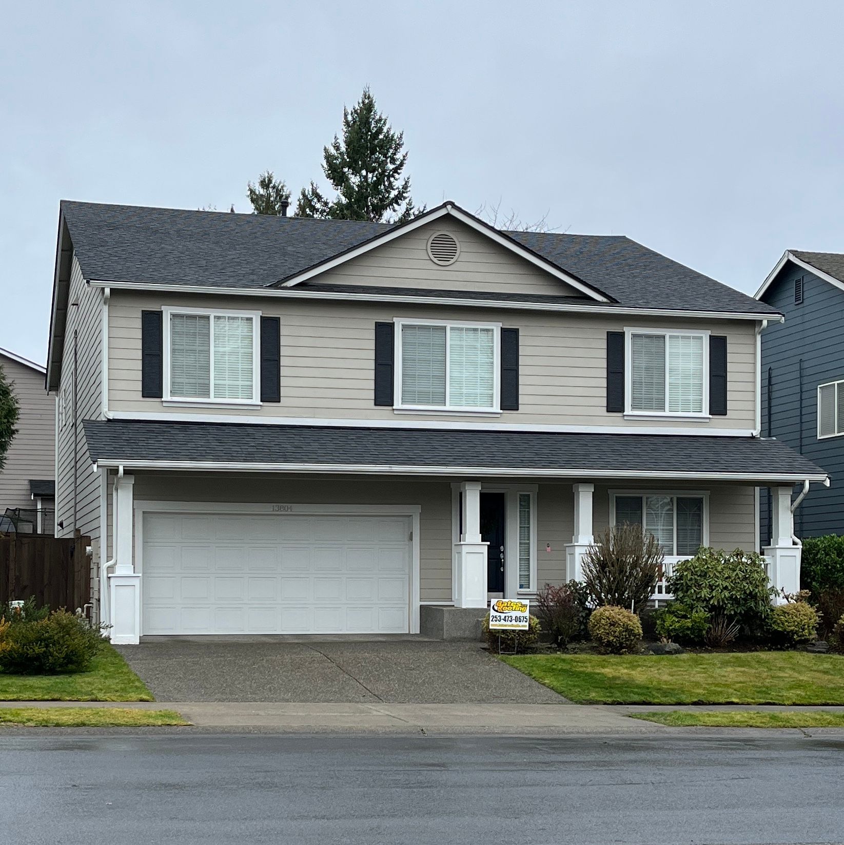 A house with a for sale sign in front of it