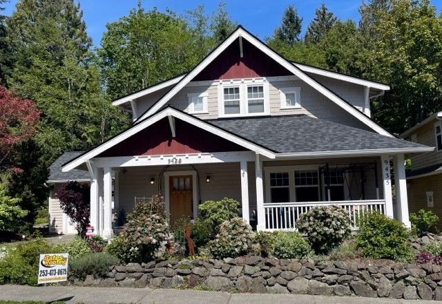 A house with a sign in front of it that says