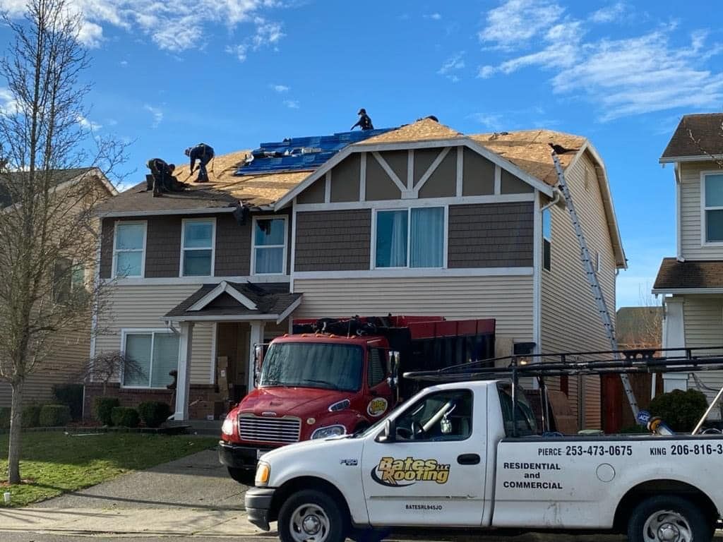 A truck is parked in front of a house that is being remodeled.