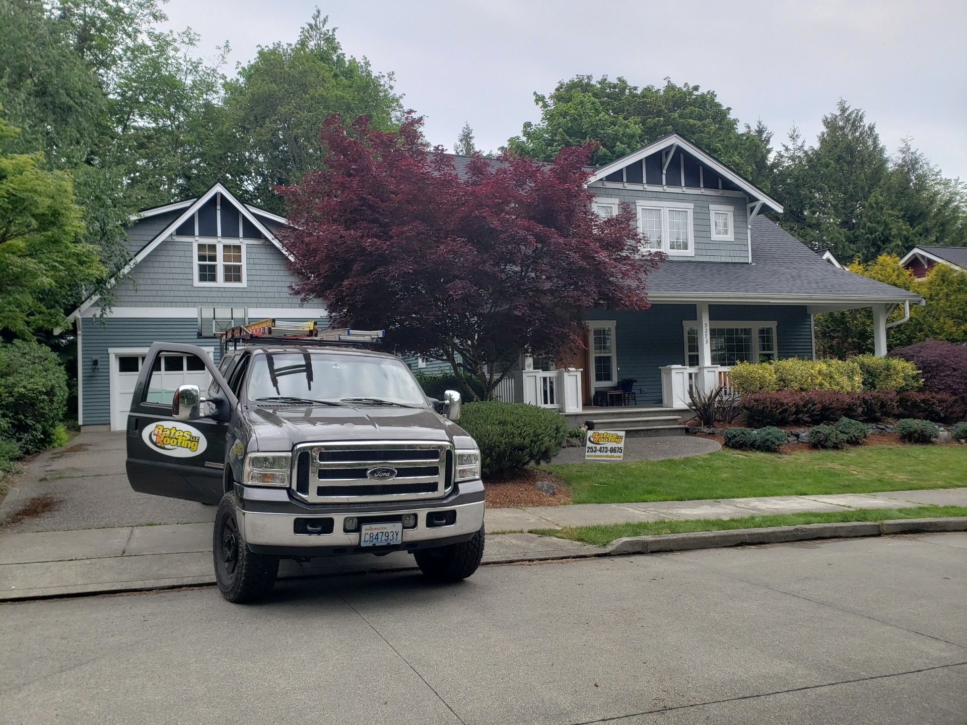 A truck is parked in front of a house.