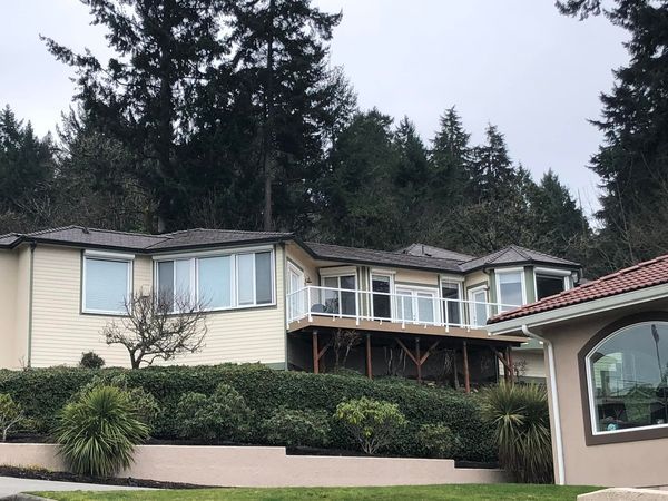 A large house on a hill with trees in the background
