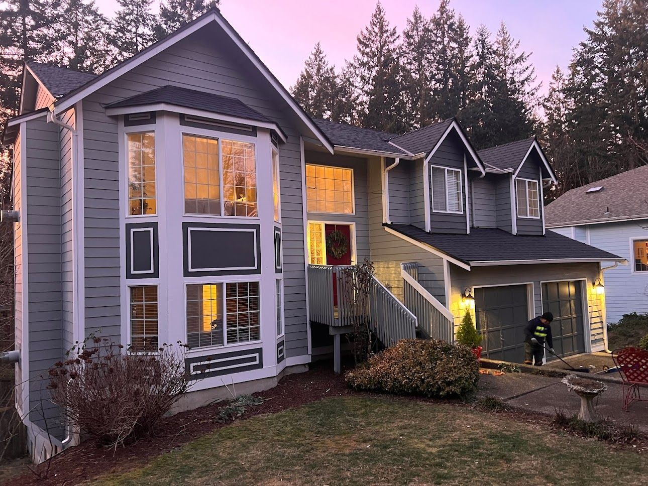 A large house with a lot of windows is lit up at night.
