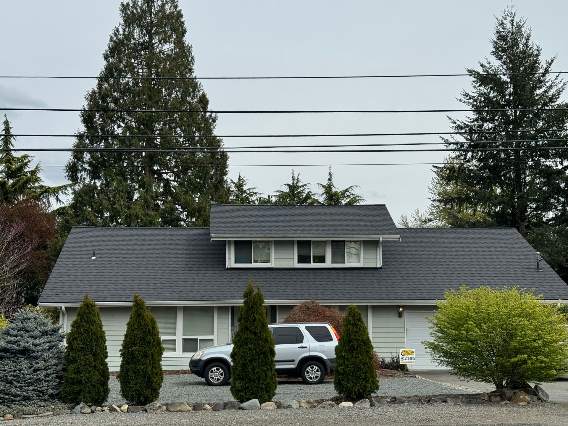 A white suv is parked in front of a house