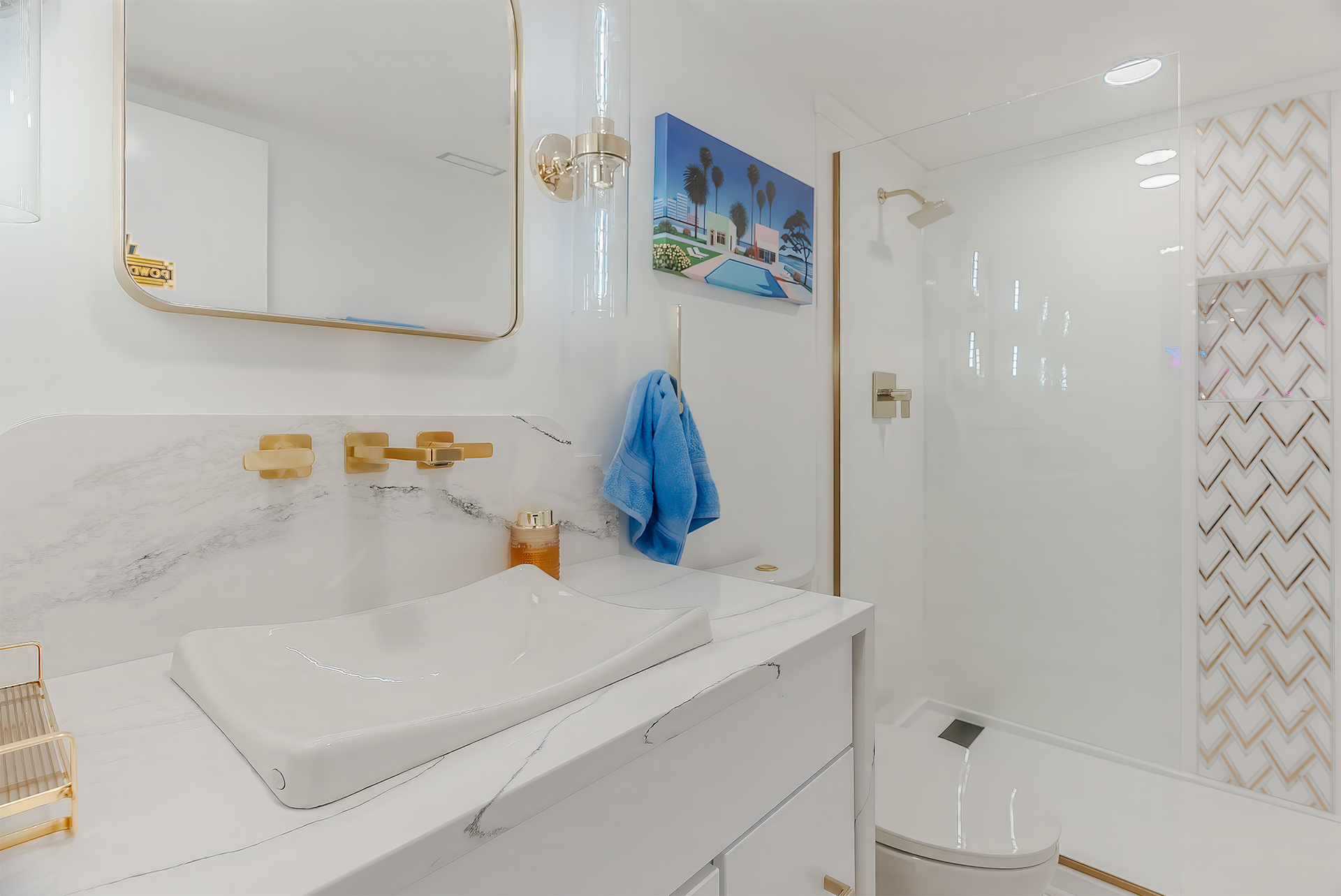 Modern white bathroom with gold accents. Features a vessel sink, marble countertop, and shower.