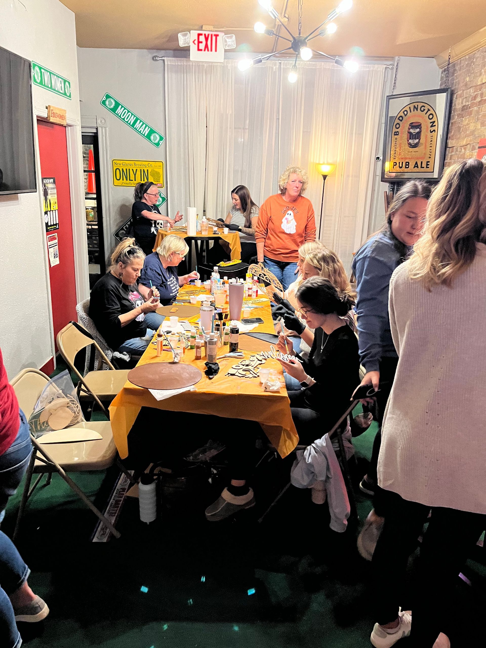 A group of people are sitting around a table in a room.