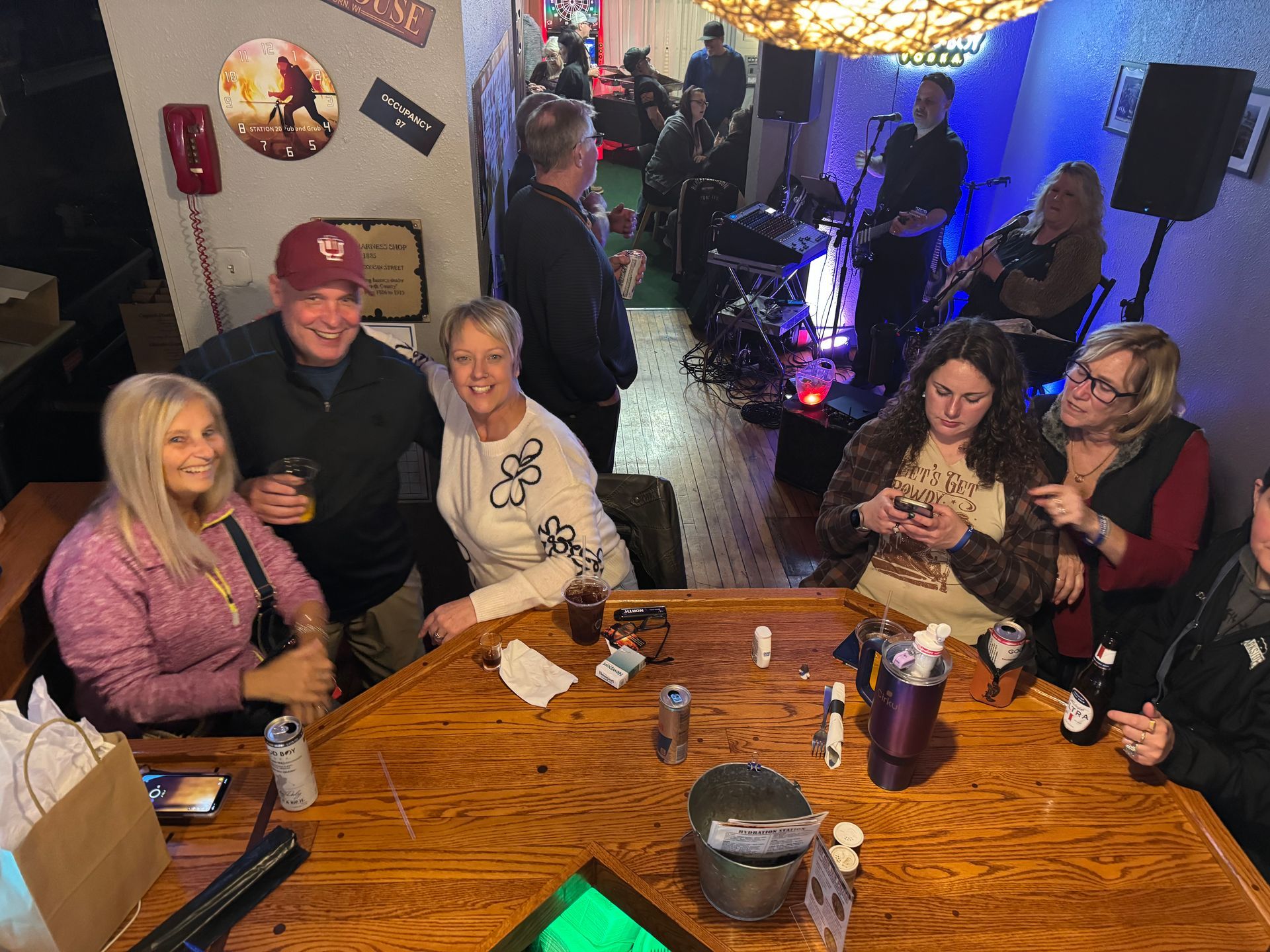 A group of people are sitting at a table in a bar.