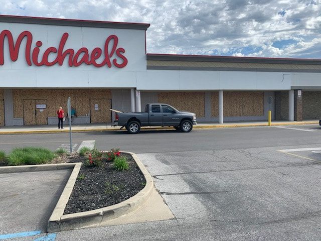 A truck is parked in front of a michael 's store.