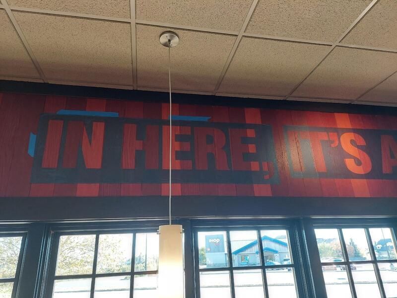 A sign on a wall that says in here it 's
