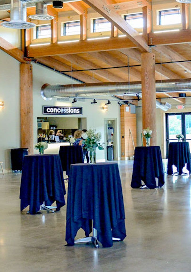 A room with tables and a sign that says concessions