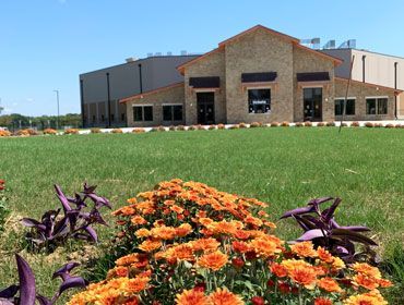 A large building with flowers in front of it