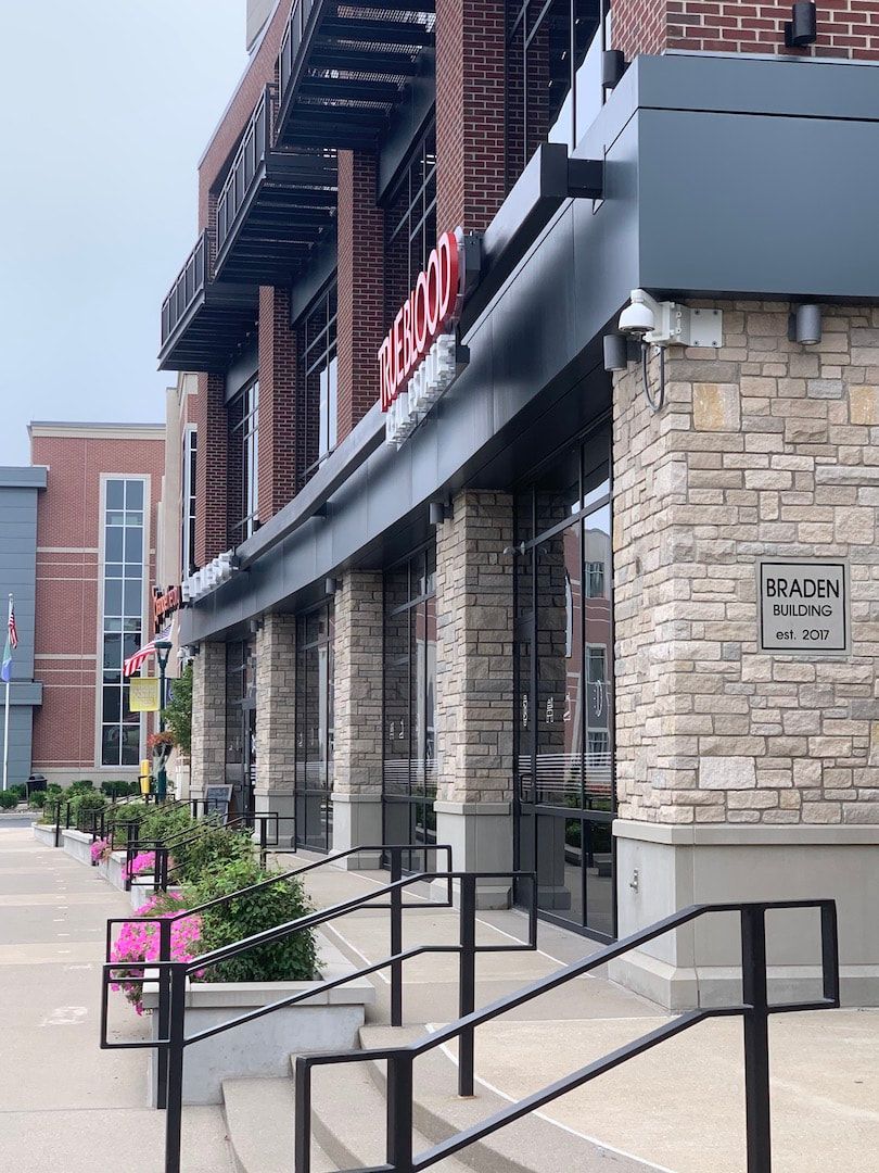 A brick building with stairs leading up to it