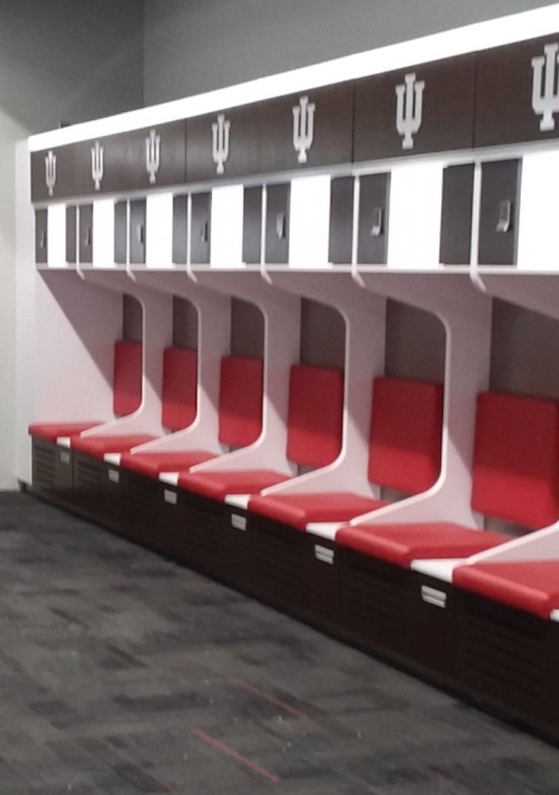 A row of red seats in a locker room