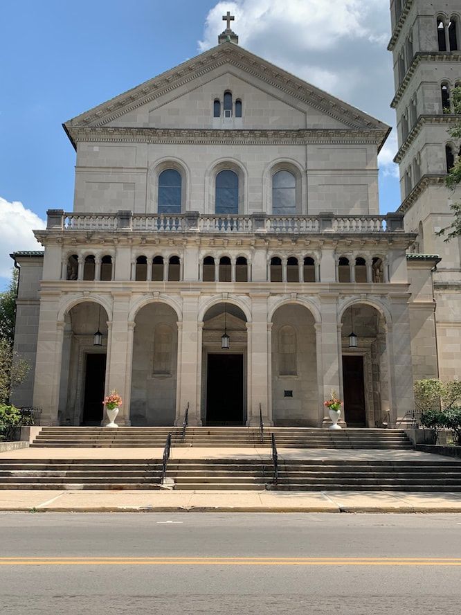 A large stone church with stairs leading up to it