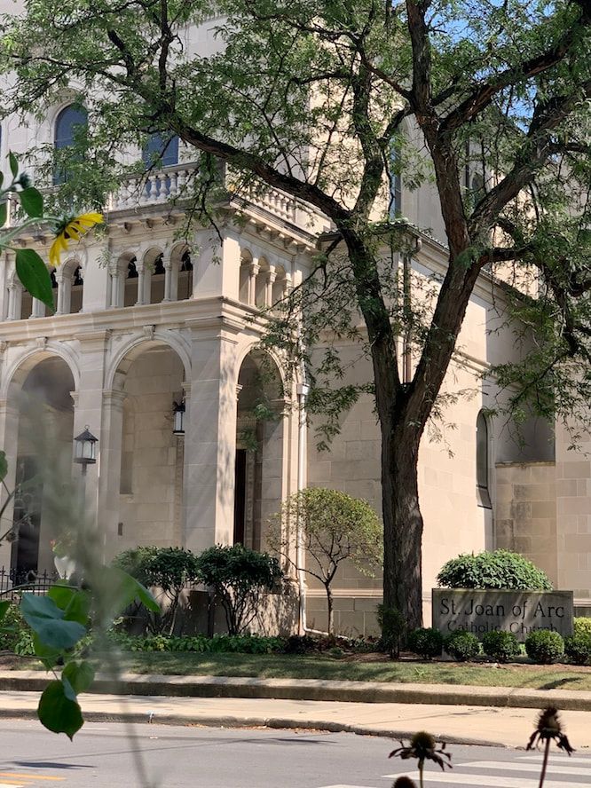 A large building with a tree in front of it.