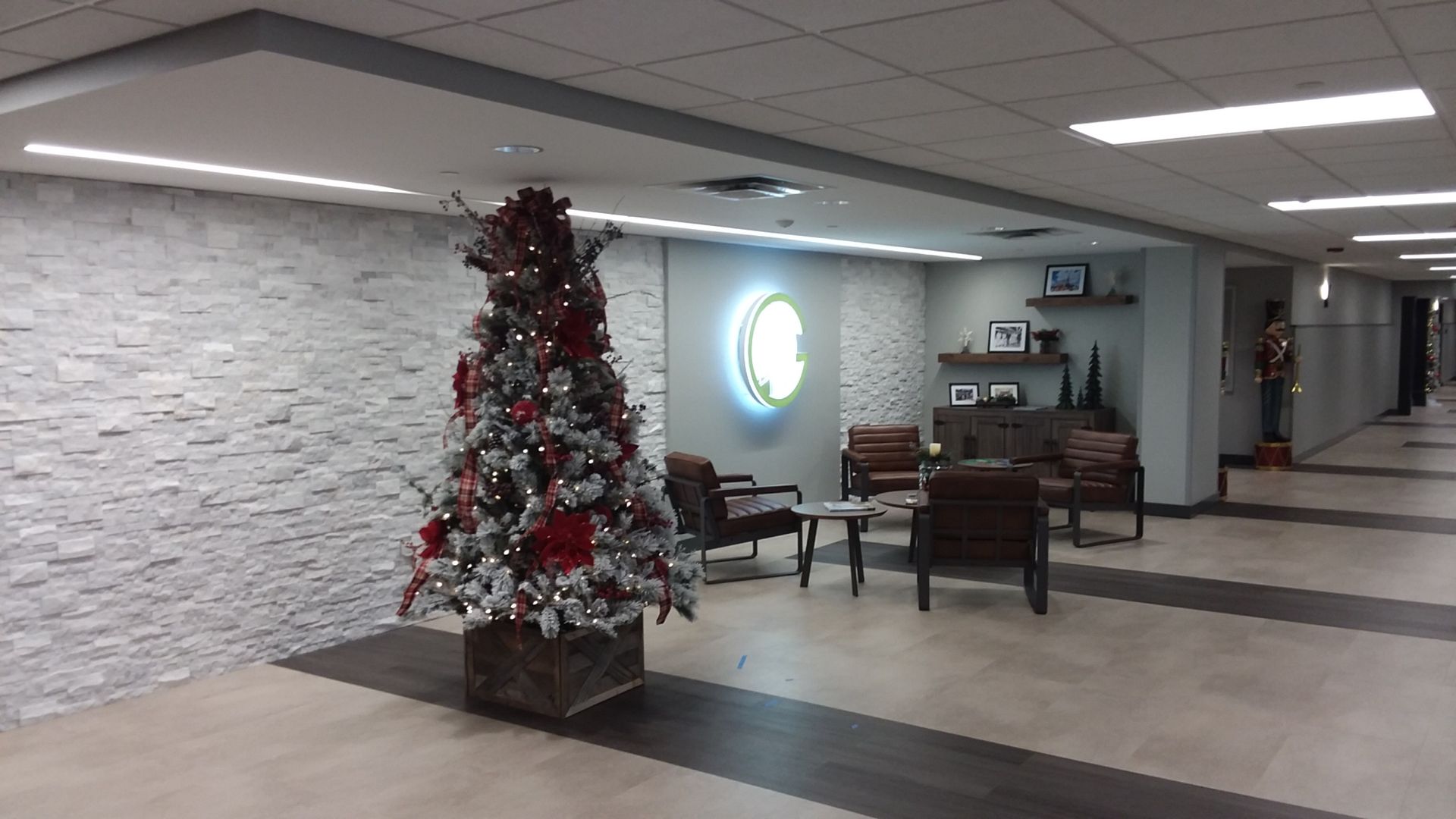 A christmas tree is in the middle of a hallway