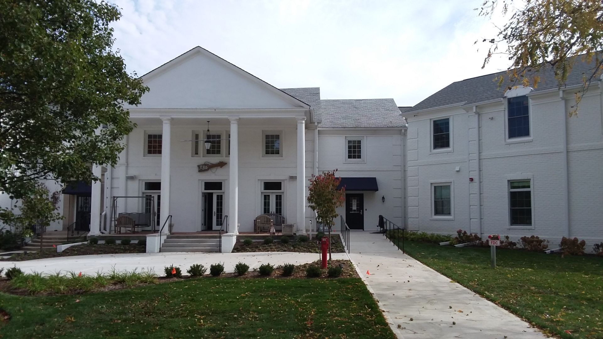 A large white house with a walkway leading to it